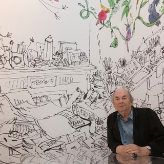 Quentin Blake posa davanti a un'illustrazione del suo studio presso la House of Illustration di King's Cross