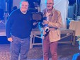 Don Matteo Pelisseri riceve dal sindaco Silvio Artusio Comba una targa riconoscimento per la sua opera religiosa a Monticello
